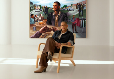 Heidi sitting in front of a mural of her life